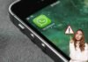 donna con segnale pericolo e icona whatsapp