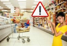 donna con simbolo allerta, carrello pieno nel supermercato