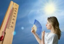 termometro, sole cocente e donna con ventaglio