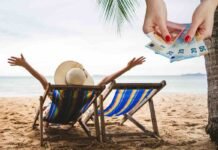 donna felice su sdraio e spiaggia di sabbia dorata con mani con euro