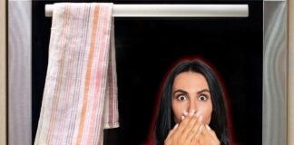 donna preoccupata e strofinaccio appeso al forno