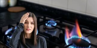 donna preoccupata e fornelli a gas