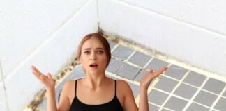 donna preoccupata e bagno con muffa