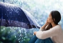 Tutti a casa questo giorno, il meteo mette i brividi: “Temporali improvvisi” donna pensierosa e ombrello con pioggia