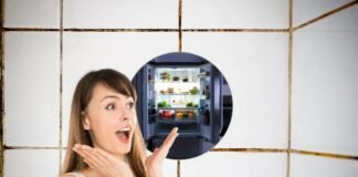 donna in primo piano stupita, frigorifero aperto e pieno e piastrelle doccia