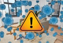 rappresentazione di una stanza piena di germi e segnale di pericolo