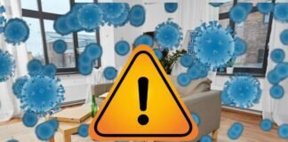 rappresentazione di una stanza piena di germi e segnale di pericolo