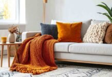 divano con cuscini e coperta arancione