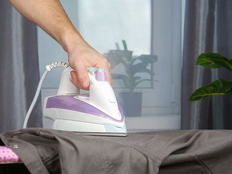 ferro da stiro che viene passato sulla camicia