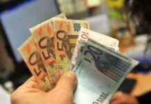 Un mazzo di soldi in mano